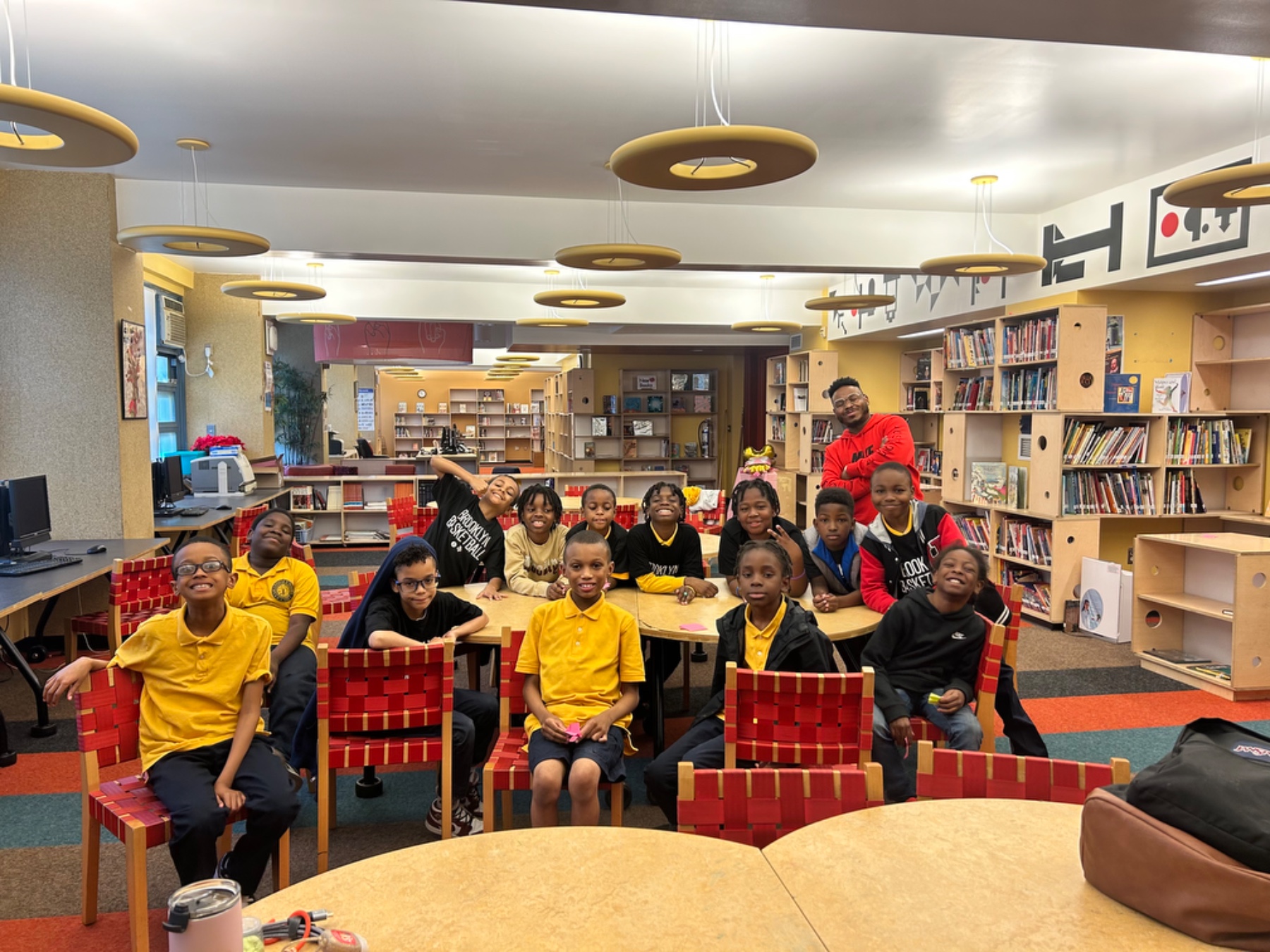 Ace Clark with a class of elementary scholars in their school library